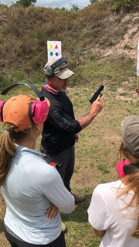 John Riddle coaching students on the range