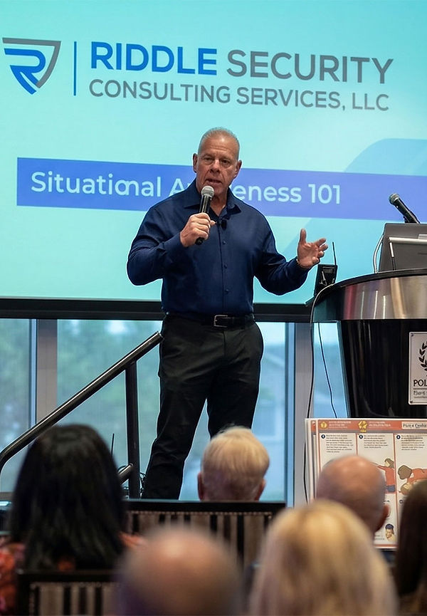 John Riddle delivering a keynote speech on personal safety and situational awareness